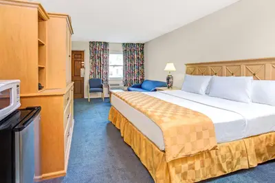 a hotel room with a bed and a television at Knights Inn Kissimmee in Kissimmee