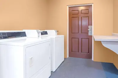 a washer and dryer in a room with a door at Knights Inn Kissimmee in Kissimmee