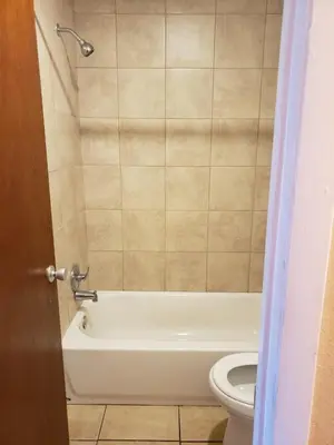 a bathroom with a white tub and a toilet at Knights Inn Kissimmee in Kissimmee