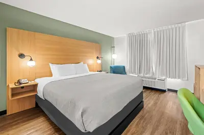 a hotel room with a bed and a desk and chair at Quality Inn Orlando Near International Drive in Orlando