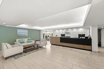 a waiting room with chairs and a reception desk at Quality Inn Orlando Near International Drive in Orlando