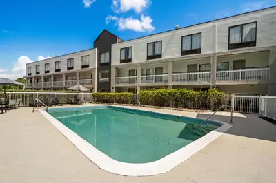 a swimming pool in front of a building at Quality Inn Orlando Near International Drive in Orlando