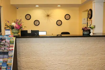 a waiting room with clocks on the wall at Shining Light Inn & Suites in Kissimmee
