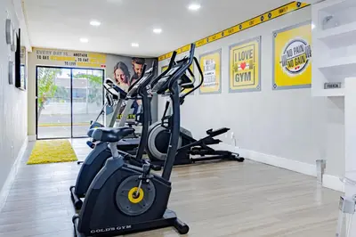a gym with two tread machines in a room at Palazzo Lakeside Hotel in Kissimmee