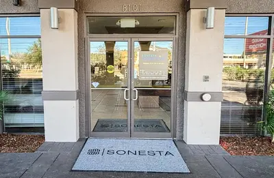an entrance to a building with a glass door at Sonesta Essential Orlando Airport in Orlando