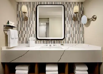 a bathroom with a marble sink and a mirror at Caribe Royale Orlando in Orlando