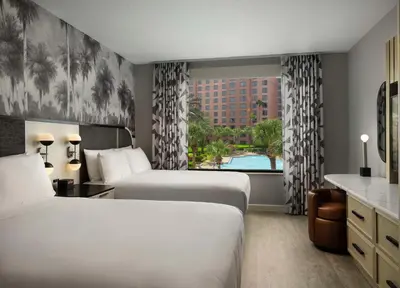 a hotel room with two beds and a window at Caribe Royale Orlando in Orlando