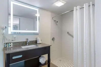 a bathroom with a sink and a shower at Clarion Inn & Suites Kissimmee-Lake Buena Vista South in Kissimmee