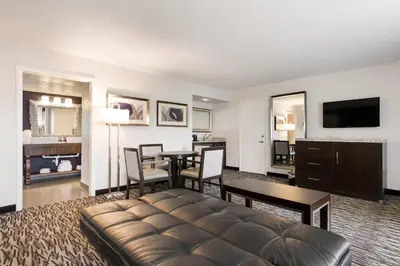 a living room with a couch and a table at Clarion Inn & Suites Across From Universal Orlando Resort in Orlando