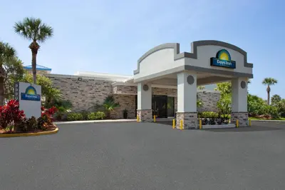 a hotel entrance with a sign in front of a building at Days Inn by Wyndham Orlando Conv. Center/International Dr in Orlando