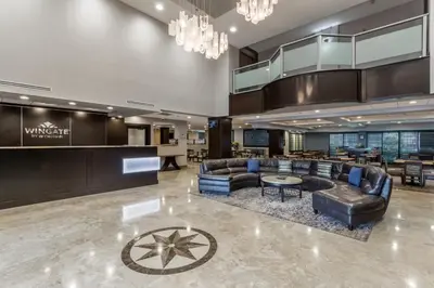 a lobby of a hotel with couches and tables at Wingate by Wyndham, Universal Studios - Free Theme Park Shuttle in Orlando