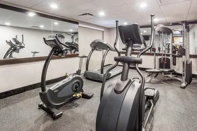 a gym with treadmills and elliptical machines at Wingate by Wyndham, Universal Studios - Free Theme Park Shuttle in Orlando