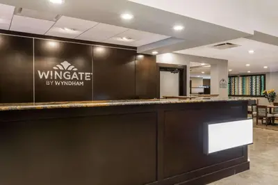 a bar in a lobby with a sign that reads wineries by window at Wingate by Wyndham, Universal Studios - Free Theme Park Shuttle in Orlando
