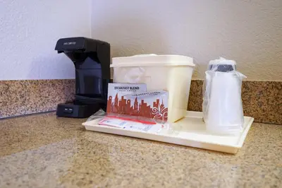 a coffee maker sitting on a counter next to a blender at Rosen Inn International Near The Parks in Orlando