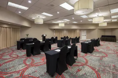 a conference room with black tables and chairs at Four Points by Sheraton Orlando International Drive in Orlando