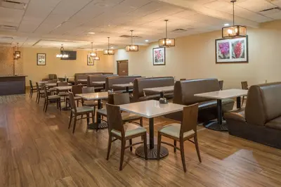a dining room filled with tables and chairs at Four Points by Sheraton Orlando International Drive in Orlando