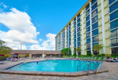 a large swimming pool in front of a building at Rosen Inn Closest to Universal in Orlando