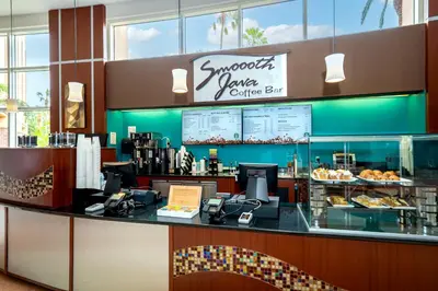 a restaurant with a counter with a coffee bar at Rosen Centre Hotel Orlando Convention Center in Orlando