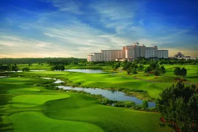 a view of a golf course with a river and buildings at Rosen Shingle Creek Universal Blvd in Orlando