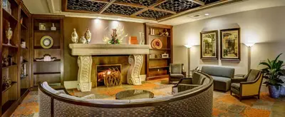 a living room with a fireplace in a room at Rosen Shingle Creek Universal Blvd in Orlando