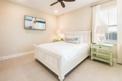 a white bedroom with a white bed and a window at Cannon Thunder Cottage With Private Hot Tub Near Disney With Margaritaville Resort & Island H2O Access - 3066Pi in Orlando