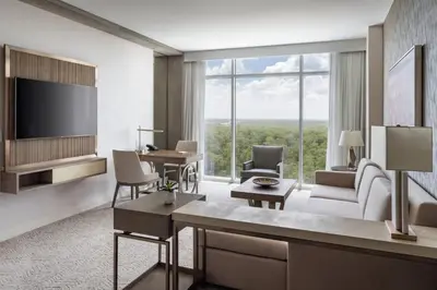 a living room with a tv and a large window at JW Marriott Orlando Bonnet Creek Resort & Spa in Orlando