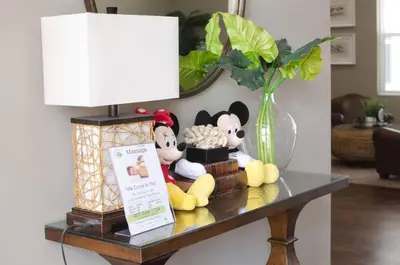 a table with stuffed animals and a lamp and a vase at Amazing private townhouse in gated community with amenities Great location, near Disney! in Kissimmee