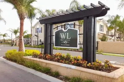 a sign for a villa with palm trees at 3 Bedroom townhouse fits 8, 10' to Disney parks! in Kissimmee