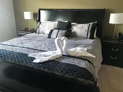 two swans sitting on top of a bed at 3 Bedroom townhouse in luxury Resort, sleeps 8, 10 min to Disney! in Kissimmee