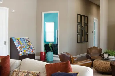 a living room with a couch and chairs and a table at Luxury 3 bedroom townhouse, comfortable sleeps 8 Super close to Disney! in Kissimmee