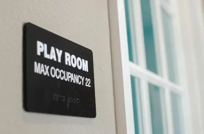 a sign on the side of a building with a window at Luxury 3 bedroom townhouse, comfortable sleeps 8 Super close to Disney! in Kissimmee