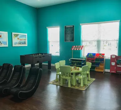 a play room with a table and a piano at Luxury 3 bedroom townhouse, comfortable sleeps 8 Super close to Disney! in Kissimmee