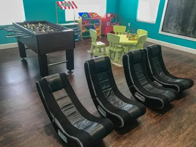a play room with a chess table and chairs at Fantastic Townhouse in Lux community sleeps 8, 10' to Disney!! in Kissimmee
