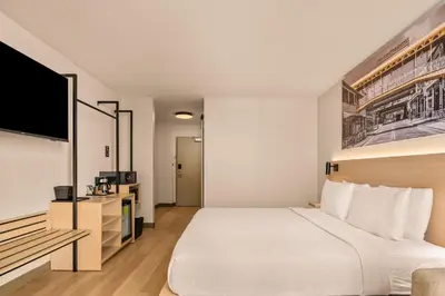 a hotel room with a bed and a flat screen tv at B&B HOTEL Orlando International Drive near Universal - Newly Renovated! in Orlando