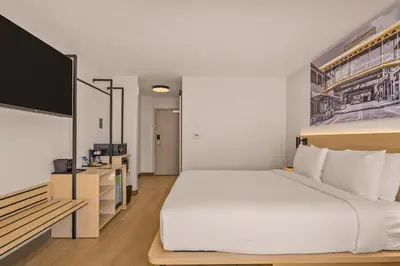 a bedroom with a bed and a flat screen tv at B&B HOTEL Orlando International Drive near Universal - Newly Renovated! in Orlando