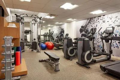 a gym with treadmills and exercise equipment in a room at Sheraton Suites Orlando Airport Hotel in Orlando