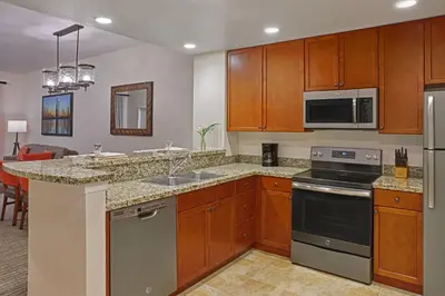 a kitchen with a sink and a stove top oven at Sheraton Vistana Villages Resort Villas, I-Drive Orlando in Orlando