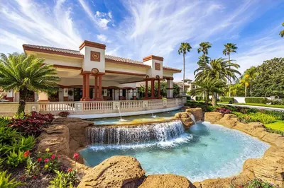 a waterfall in front of a house with a fountain at Sheraton Vistana Villages Resort Villas, I-Drive Orlando in Orlando