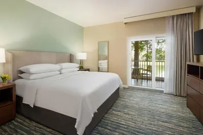 a bedroom with a large white bed and a balcony at Sheraton Vistana Resort Villas, Lake Buena Vista Orlando in Orlando