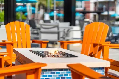 a table with chairs and a fire pit on it at Vista Cay at Epic Universe - Luxury 3 bedroom Townhouse in Orlando