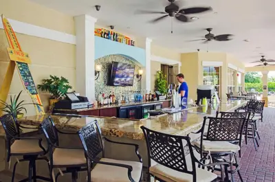 a man standing at a bar in a restaurant at Vista Cay at Epic Universe - Luxury Lakeview 4 bedroom condo in Orlando
