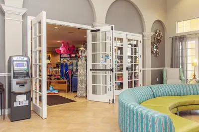 a clothing store with a couch and a ticket machine at Vista Cay at Epic Universe - Luxury Lakeview 4 bedroom condo in Orlando