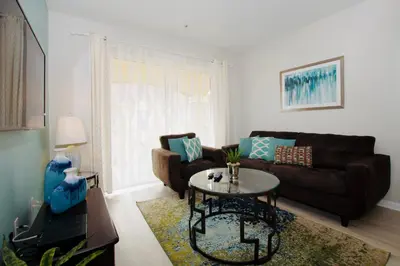 a living room with a couch and a table at Vista Cay at Epic Universe - Standard 2 bedroom condo in Orlando