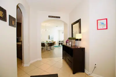 a living room with a hallway with a dining room at Vista Cay at Epic Universe - Standard 3 bedroom condo in Orlando