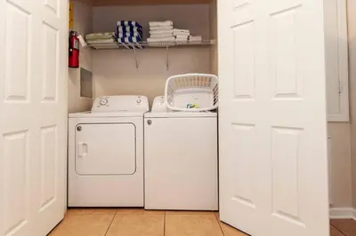 a white laundry room with a washer and dryer at Vista Cay at Epic Universe - Standard 3 bedroom condo in Orlando