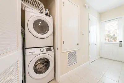 a laundry room with a washer and dryer at Livin' For The Weekend Cottage Near Disney With Margaritaville Resort & Island H2O Access - 8021Ff in Orlando