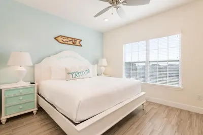 a white bedroom with a bed and a window at Blue Oasis Cottage With Private Pool Near Disney And Margaritaville Resort & Island H20 Access - 7968Sh in Orlando