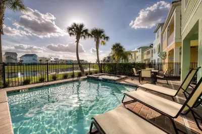 a swimming pool with two chairs and palm trees at Smooth Sailing Cottage With Private Pool Near Disney And Margaritaville Resort & Island H20 Waterpark Access - 7992Sh in Orlando