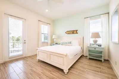 a white bedroom with a bed and two windows at Sea Breeze Cottage Near Disney With Private Hot Tub & Margaritaville Resort & Island H20 Waterpark Access - 3016Sr in Orlando