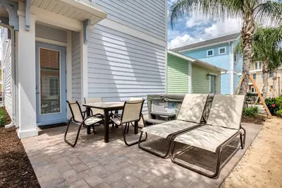 a patio with a table and chairs and a table and chairs at Premium Cottage With Private Hot Tub Near Disney Margaritaville Resort & Island H2O Access - 3025La in Orlando